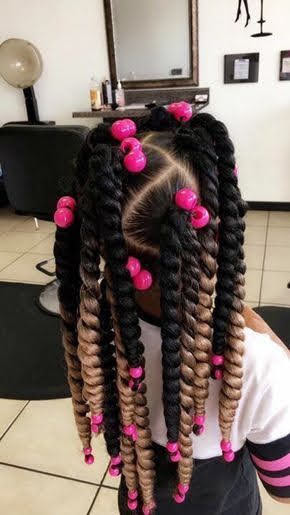 Twisted Black girl hairstyle for school with pink accessories 